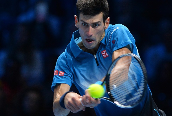 Serbia's Novak Djokovic returns to Switzerland's Roger Federer during the men's singles final match on day eight of the ATP World Tour Finals tennis tournament in London on November 22, 2015.  AFP PHOTO / GLYN KIRK        (Photo credit should read GLYN KIRK/AFP/Getty Images)