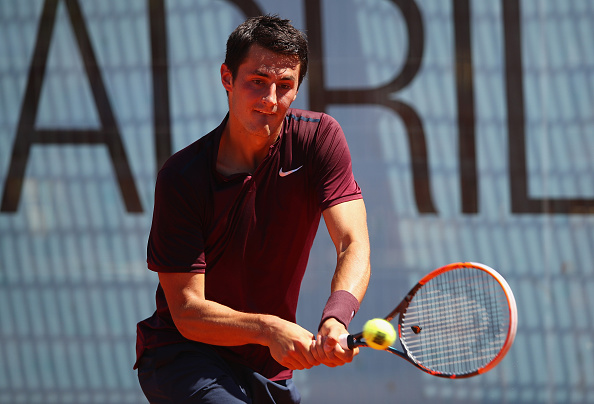 MADRID, SPAIN - MAY 03:  Bernard Tomic of Australia plays a backhand against Fabio Fognini of Italy in their first round match during day four of the Mutua Madrid Open tennis tournament at the Caja Magica on May 03, 2016 in Madrid,Spain.  (Photo by Clive Brunskill/Getty Images)