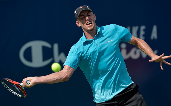 WINSTON SALEM, NC - AUGUST 25:  John Millman of Australia returns a shot to Richard Gasquet of France during the Winston-Salem Open at Wake Forest University on August 25, 2016 in Winston Salem, North Carolina.  (Photo by Grant Halverson/Getty Images)